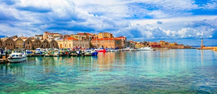 Photo of aerial view of Chania with the amazing lighthouse, mosque, venetian shipyards, Crete, Greece.