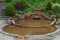 Photo of beautiful waterfall and Vesica Pool in the Chalice Well Garden, Glastonbury, England.