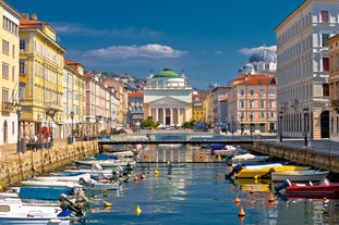 Famous buildings, gondolas and monuments by the Rialto Bridge of Venice on the Grand Canal, Italy.