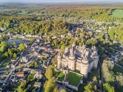 photo of aerial view over the beautiful Castle of Pierrefonds in Pierrefonds, France.
