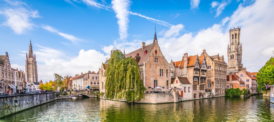 Panoramic city view with Belfry tower and famous canal in Bruges, Belgium.