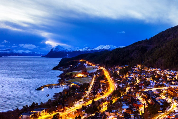 photo of view of  Molde, Norway. Aerial view of residential area in Molde, Norway at night. Beautiful fjord with mountains in winter