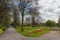 Photo of beautiful colourful flower beds and green grass of St Nicholas Park, on a warm spring day, Warwick, United Kingdom.