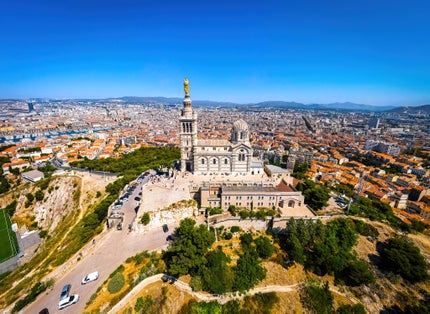 Photo of the aerial view of Basilique Notre-Dame-de-la-Garde in Marseille, a port city in southern France.