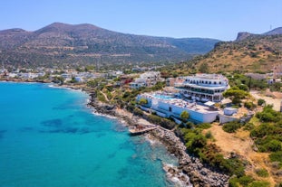 Photo of aerial view of Malia beach and small island with Church of Transfiguration, Heraklion, Crete, Greece.