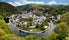 Aerial view of Esch-sur-Sure, medieval town in Luxembourg, dominated by castle, canton Wiltz in Diekirch. Forests of Upper-Sure Nature Park, meander of winding river Sauer, near Upper Sauer Lake.