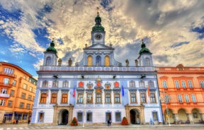 Photo of Lednice Chateau with beautiful gardens and parks on a sunny summer day, Czech Republic.