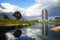 Photo of Parque del Agua Zaragoza, Water Tower and a lake with a nice reflection of the tower and a tree .