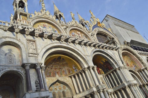 photo of Tourist site of St Mark's Square in Venice, Italy, tall St Mark's tower, the San Marco Basilica cathedral and other baroque and gothic sites in the most famous piazza in the city of Venezia.