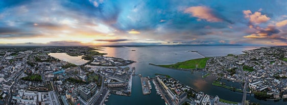 Aerial view of Dublin city center at sunset with River Liffey and Samuel Beckett bridge in the middle. Bridge designed by Santiago Calatrava.