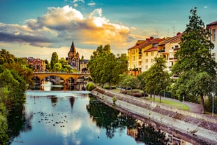 Photo of traditional half-timbered houses on picturesque canals in La Petite France in the medieval fairytale town of Strasbourg, France.