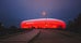 Photo of Allianz Arena, the football stadium of FC Bayern, illuminated in red at night, Germany.