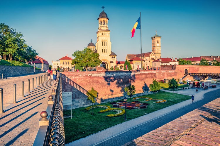 photo of view of Attractive evening view of bell tower of Reunification Cathedral, Fortified churches inside Alba Carolina Fortress. Sunny summer scene of Transylvania, Alba Iulia city, Romania, Europe.