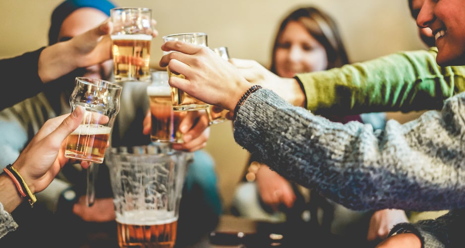 Happy friends cheering with half pints beer in pub restaurant.jpg