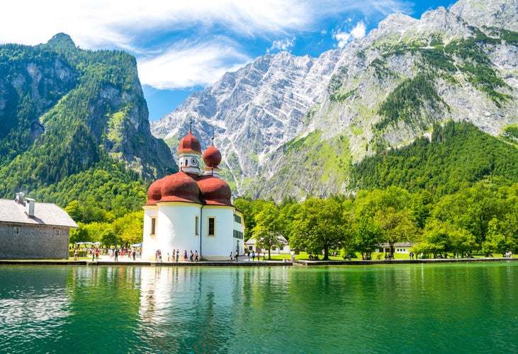 Photo of Konigsee lake with st Bartholomew church surrounded by mountains, Berchtesgaden National Park, Bavaria, Germany .