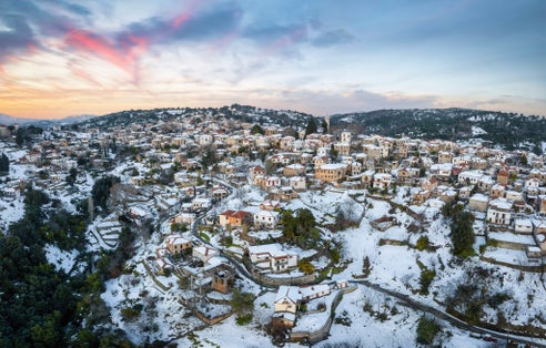 photo of view Panoramic aerial view of the snow covered village of Lafkos, South Pelion, Greece, during a winter sunset, Pelion, Greece. 