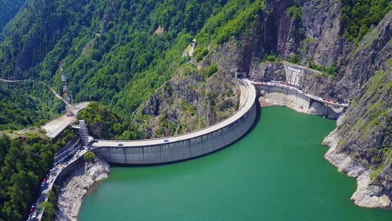 Photo of aerial view of Vidraru Dam built to create an artificial reservoir lake for hydro electricity production in Fagaras Mountains, Romania.