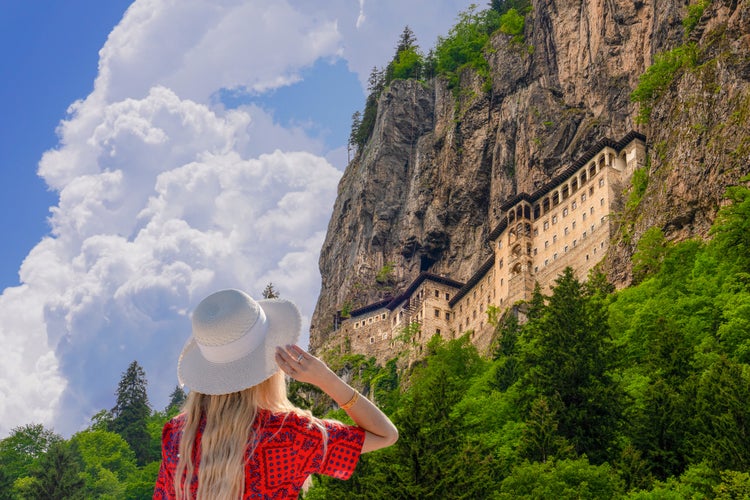 Photo of tourist woman watches Sumela Monastery in Trabzon, Turkey.