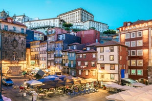 Porto, Portugal old town ribeira aerial promenade view with colorful houses, Douro river and boats.