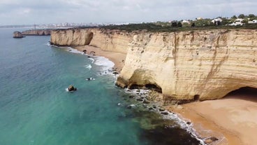 Photo of aerial view of touristic Portimao with wide sandy Rocha beach, Algarve, Portugal.