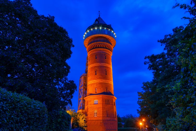 Photo of Illuminated historical water tower in Mülheim Ruhr at night.