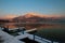 photo of Alpine Lake Lac d'Annecy (third largest lake in France) at city Annecy in evening. French Apls peaks white with snow.