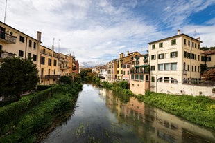 Photo of beautiful view of canal with statues on square Prato della Valle and Basilica Santa Giustina in Padova (Padua), Veneto, Italy.