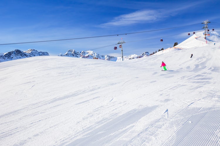 View to Ski slopes with the corduroy pattern and cable car on the top of Fellhorn Ski resort, Bavarian Alps, Oberstdorf, Germany