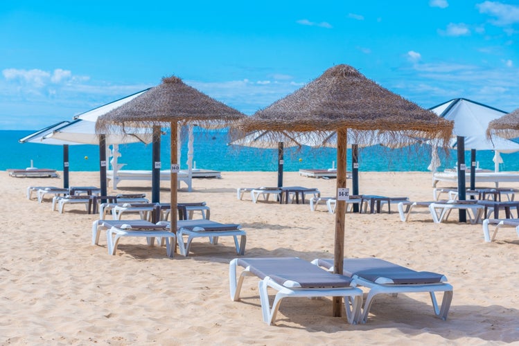 Photo of sunbeds at Ilha de Tavira beautiful beach in Portugal.