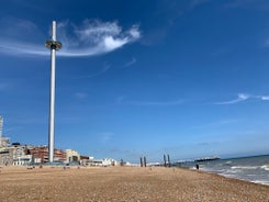 Photo of panoramic view along Brighton Beachfront with the promenade and Ferris Wheel backed by highrise buildings, UK.