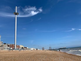 Photo of panoramic view along Brighton Beachfront with the promenade and Ferris Wheel backed by highrise buildings, UK.