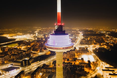 photo of aerial night view of illuminated Vilnius TV tower. Nightlife of Vilnius, Lithuania.