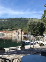 photo of aerial panoramic view of beautiful town of Lovran and sea walkway in Croatia.