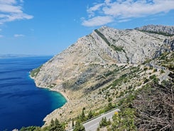 Photo of panorama and landscape of Makarska resort and its harbour with boats and blue sea water, Croatia.