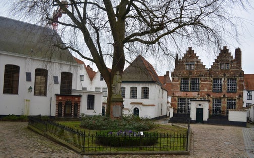 photo  of view  of White houses of local beguinage are one of the most remarkable attractions of belgian city kortrijk/courtrai.