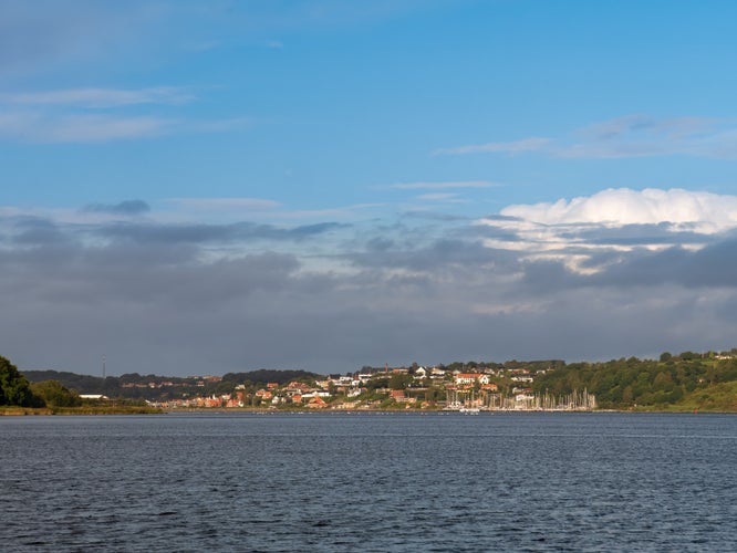 photo of view of Autumn panorama of Mariager Fjord coastline near Hobro, Himmerland, Nordjylland, Denmark, with forested hills