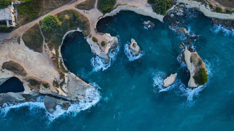 Aerial view of Faraglioni of Sant'Andrea, Salento coastline, Italy. Birds Eye view of Melendugno, province of Lecce,Italy.