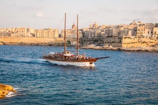 Photo of Msida Marina boat and church reflection into water, Malta.