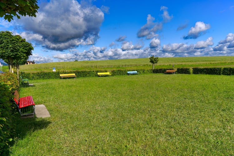 Photo of Scenic view of public park with colorful benches at viewpoint of Zürich Airport on a sunny spring day. Photo taken May 28th, 2024, Kloten, Switzerland.