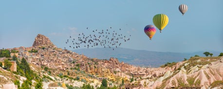 Hot air balloons flying over Uchisar Castle. Cappadocia. Nevsehir Province. Turkey.