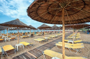 photo of umbrellas and chairs on the beach in Nea Flogita in Halkidiki, Greece.