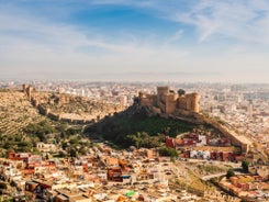 Photo of aerial view of Jaen with cathedral and Sierra Magina mountains on background, Andalusia, Spain.