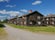 photo of wooden houses of Church Town Bonnstan on a sunny summer day with a few clouds in the sky in Skellefteå, Sweden.