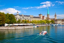 Geneva skyline cityscape, French-Swiss in Switzerland. Aerial view of Jet d'eau fountain, Lake Leman, bay and harbor from the bell tower of Saint-Pierre Cathedral. Sunny day blue sky.