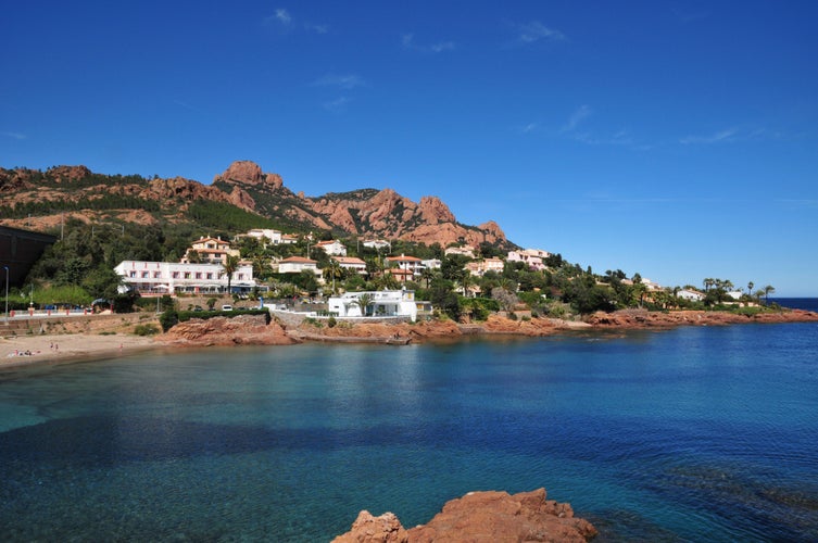 Esterel mediterranean red rocks coast, beach, tree and sea. French Riviera in Cote d Azur near Cannes Saint Raphael, Provence, France, Europe.