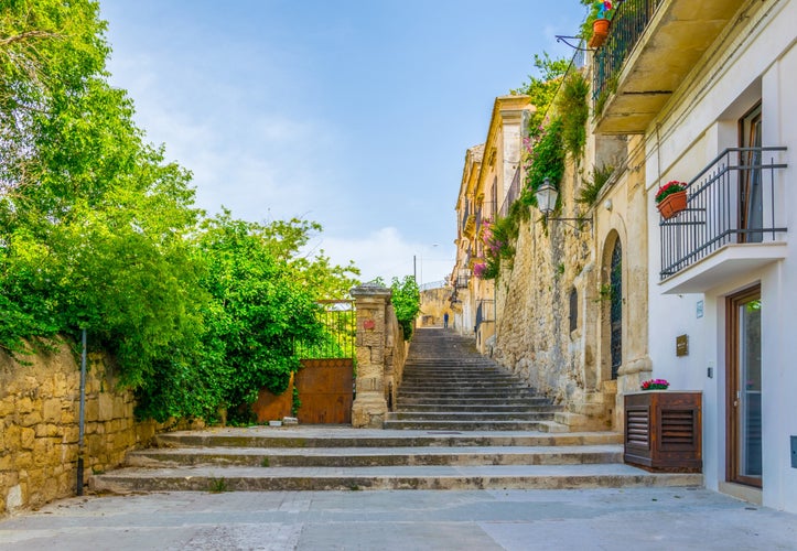 Photo of stairway in Modica in Sicily overlooking city beneath it, Italy.