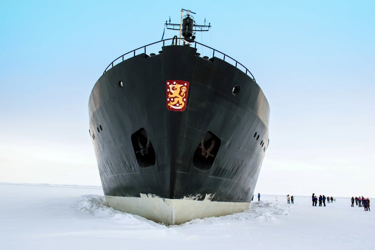 Kemi, Lapland, Finland - Tourists boarding the Arctic icebreaker ship Sampo on the frozen Gulf of Bothnia. The retired icebreaker (built 1961) now takes tourist cruises in winter.