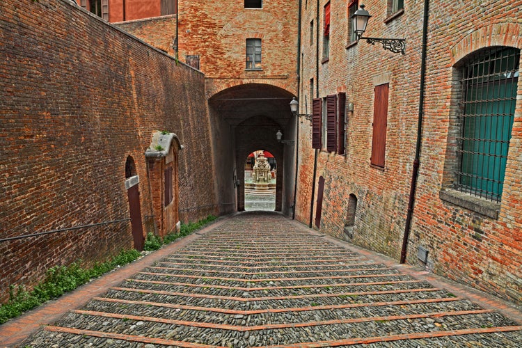 Photo of old staircase and underpass leading to the main city square with the ancient fountain, Cesena, Emilia-Romagna, Italy.