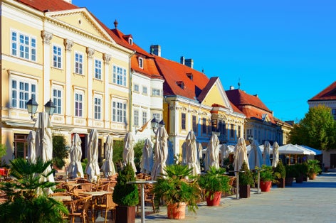 Morning old town view, street terraces of restaurants, green plants and historical architecture, Gyor, Hungary
