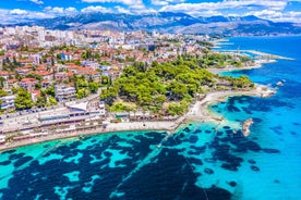 Photo of panorama and landscape of Makarska resort and its harbour with boats and blue sea water, Croatia.